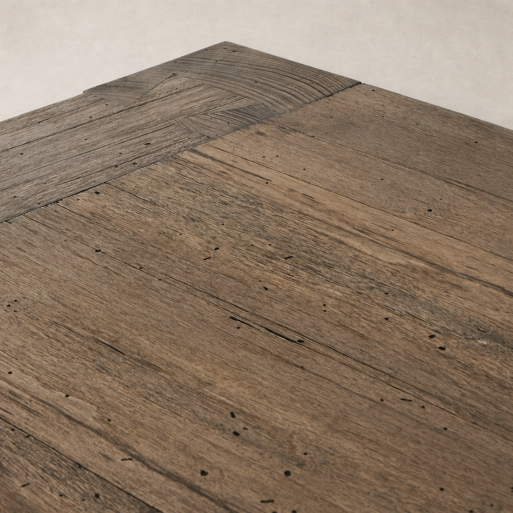 Close-up of the Brisa Dining Table in rustic wormwood oak, showcasing its textured surface.