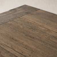 Close-up of the Brisa Dining Table in rustic wormwood oak, showcasing its textured surface.