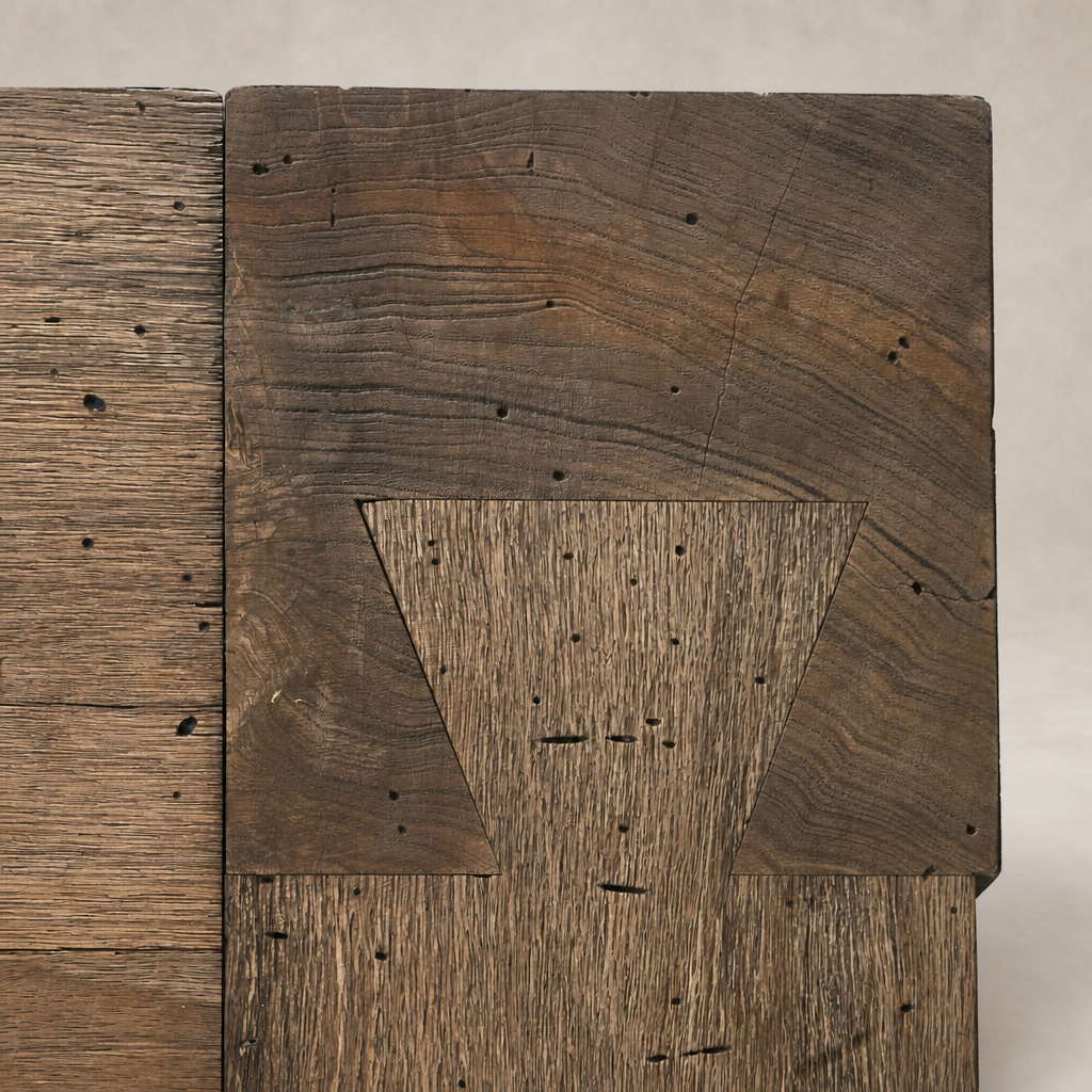 Close-up of Brisa Dining Table showcasing rustic Wormwood Oak wood texture and intricate joinery.