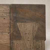 Close-up of Brisa Dining Table showcasing rustic Wormwood Oak wood texture and intricate joinery.