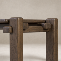 Detailed view of the Maeve Console Table in grey reclaimed French oak, showcasing its sturdy legs and unique joinery.