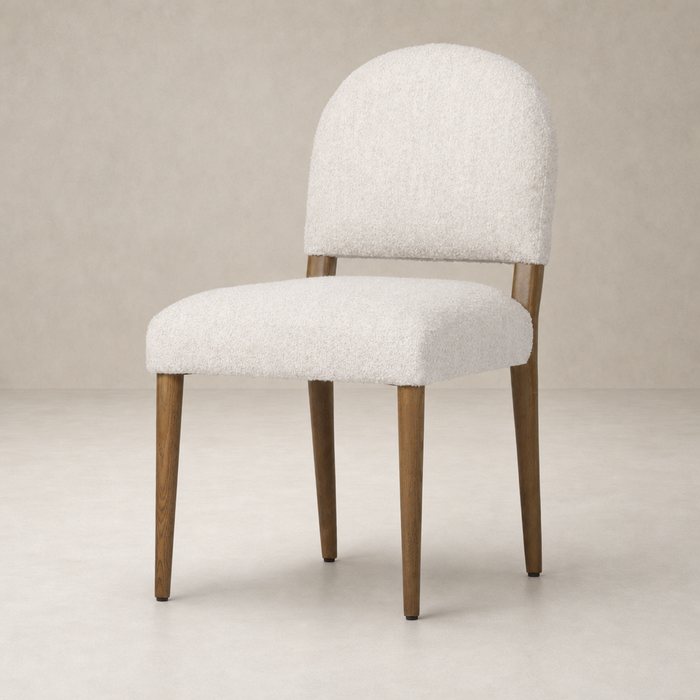 Marfa Dining Chair in Somerton Ash with soft, textured upholstery and slender wooden legs.
