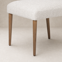 Marfa Dining Chair in Somerton Ash with textured fabric and elegant wooden legs.