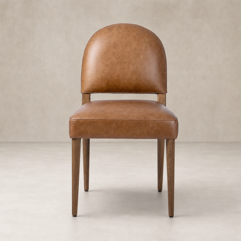 Marfa Dining Chair in Chaps Saddle with a rounded back and sleek wooden legs.