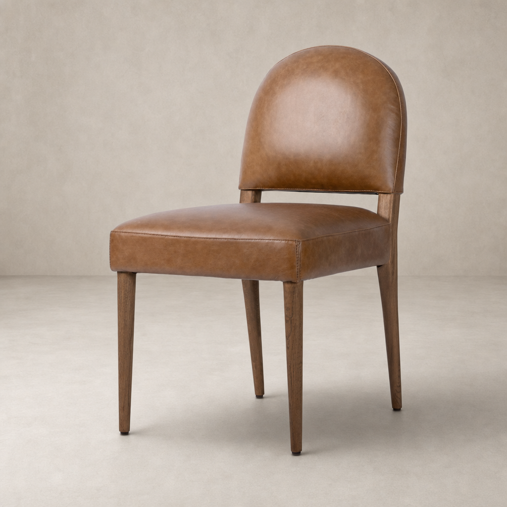 Marfa Dining Chair in Chaps Saddle with a sleek, curved back and wooden legs.