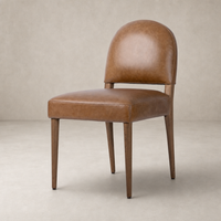 Marfa Dining Chair in Chaps Saddle with a sleek, curved back and wooden legs.