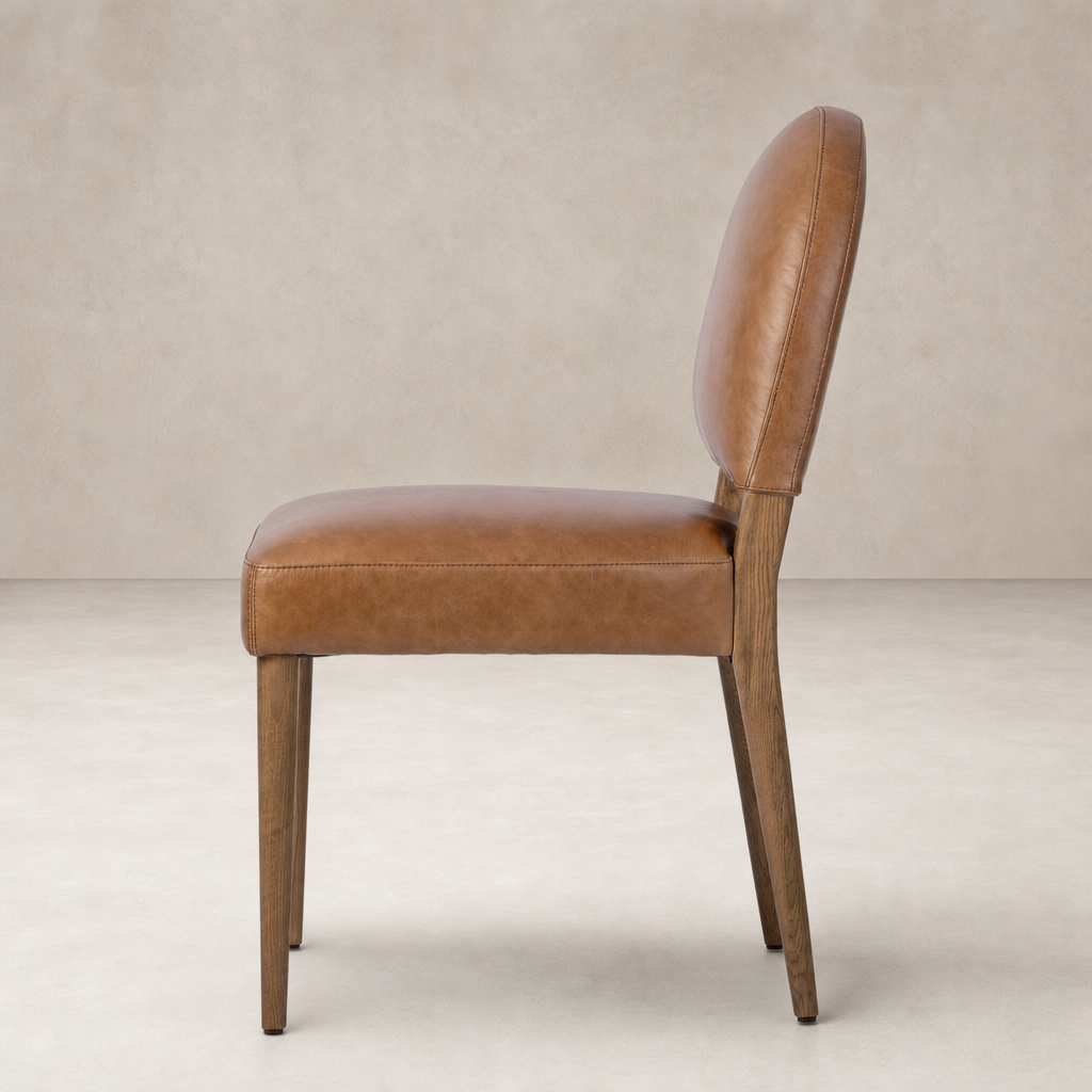 Marfa Dining Chair in Chaps Saddle with curved back and wooden legs, showcasing modern elegance.
