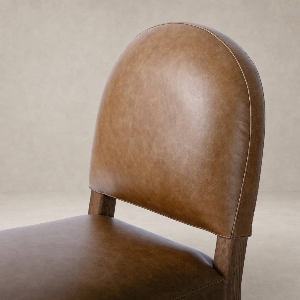 Marfa Dining Chair in Chaps Saddle features a rounded back and sleek design.