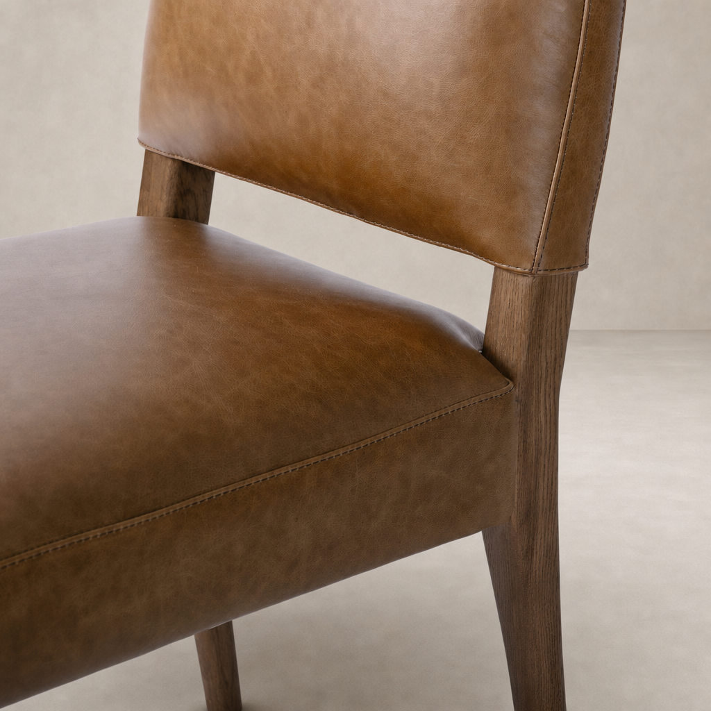 Marfa Dining Chair in Chaps Saddle with smooth leather upholstery and wooden legs.