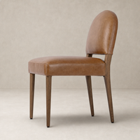 Marfa Dining Chair in Chaps Saddle featuring a curved back and wooden legs.