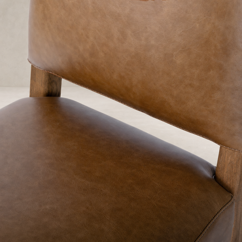 Marfa Dining Chair in Chaps Saddle with smooth leather and wooden legs.
