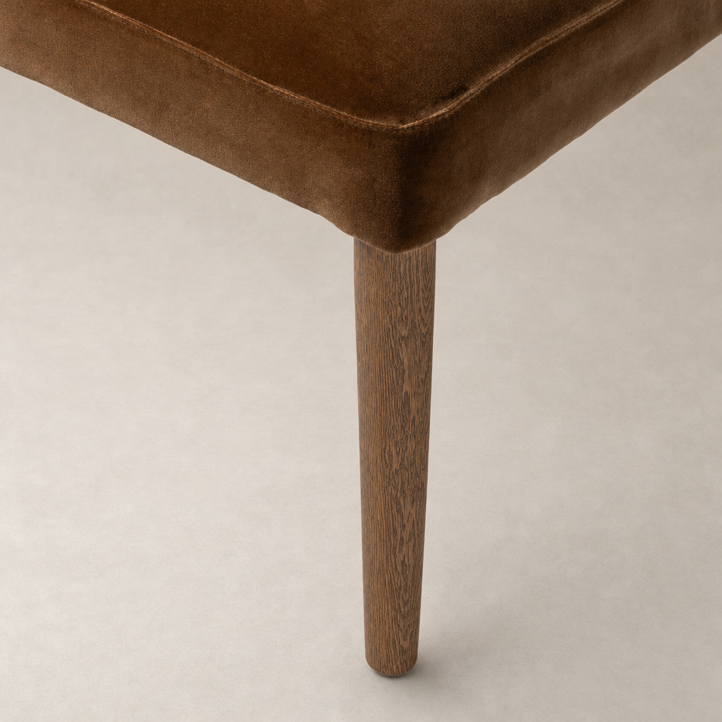 Surrey Ochre Marfa Dining Chair showing smooth upholstery and tapered wooden legs.