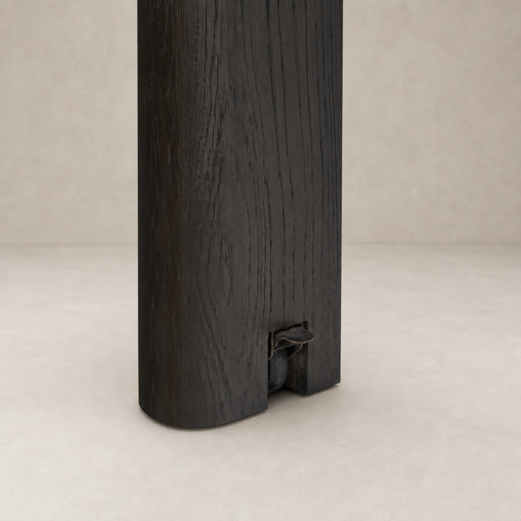 Close-up of the Stratton Extension Dining Table leg in Cracked Smoked Black finish.