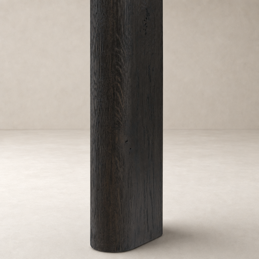 Close-up of the Stratton Extension Dining Table leg in Cracked Smoked Black finish, showcasing its textural detail.