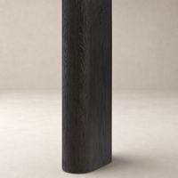 Close-up of the Stratton Extension Dining Table leg in Cracked Smoked Black finish, showcasing its textural detail.