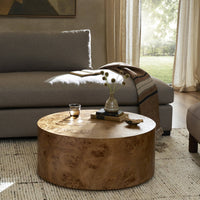 Calla Coffee Table in Caramel Burl with a smooth, round shape and natural wood grain.