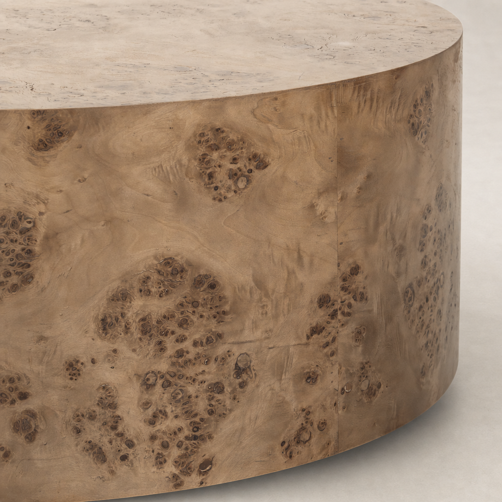 Calla Coffee Table in caramel burl showcases a round, textured surface with intricate wood grain details.