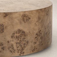 Calla Coffee Table in caramel burl showcases a round, textured surface with intricate wood grain details.