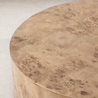 Close-up of Calla Coffee Table in caramel burl showcasing unique wood grain texture.