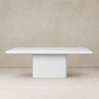 Selby Dining Table in plaster molded concrete with a smooth, minimalist design.