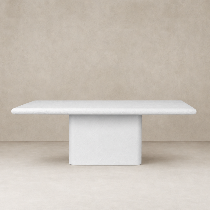 Selby Dining Table in plaster molded concrete with a smooth, minimalist design.