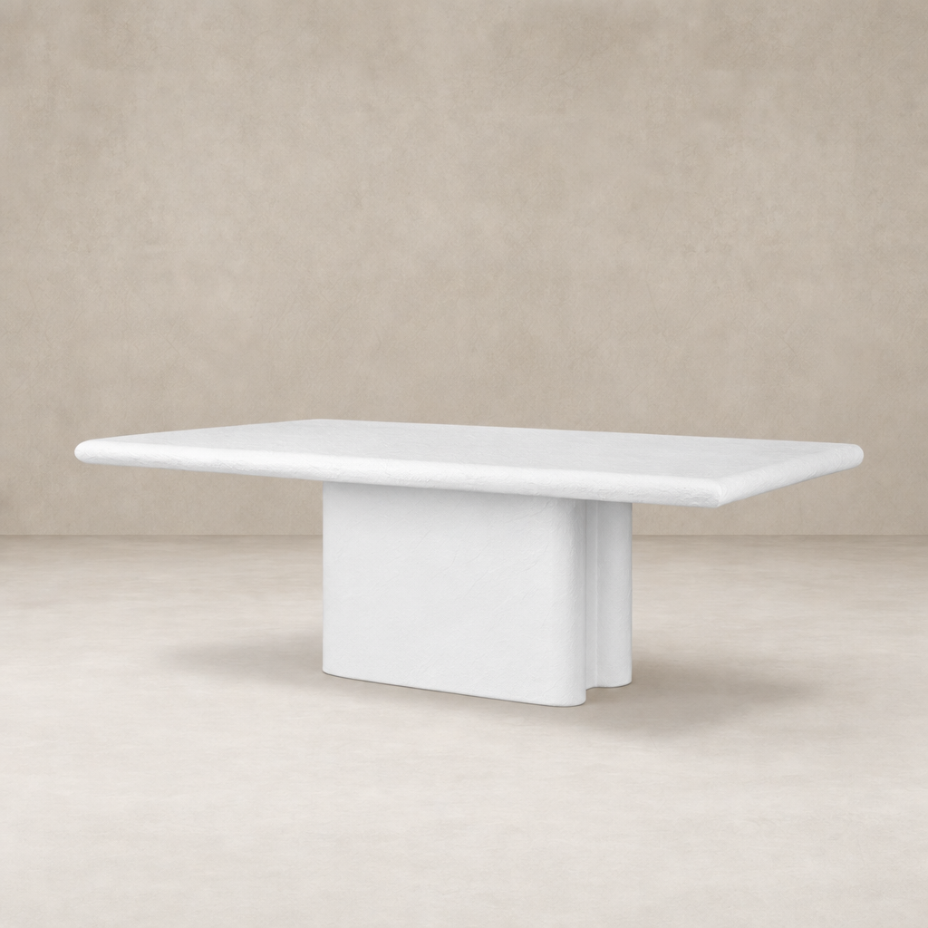 Selby Dining Table in plaster molded concrete featuring a sleek rectangular top and unique base.