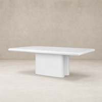 Selby Dining Table in plaster molded concrete featuring a sleek rectangular top and unique base.