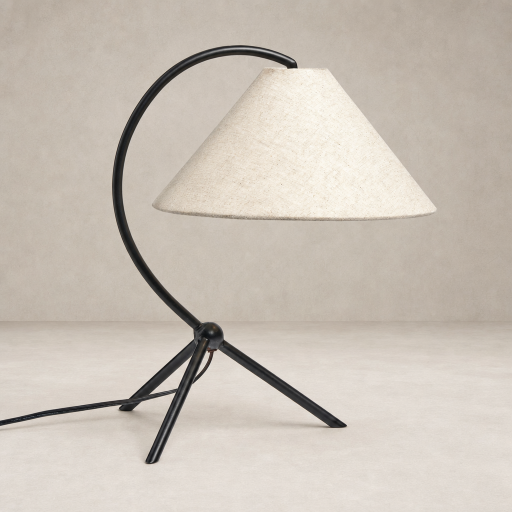 Matte black table lamp with a curved arm and a conical fabric shade.