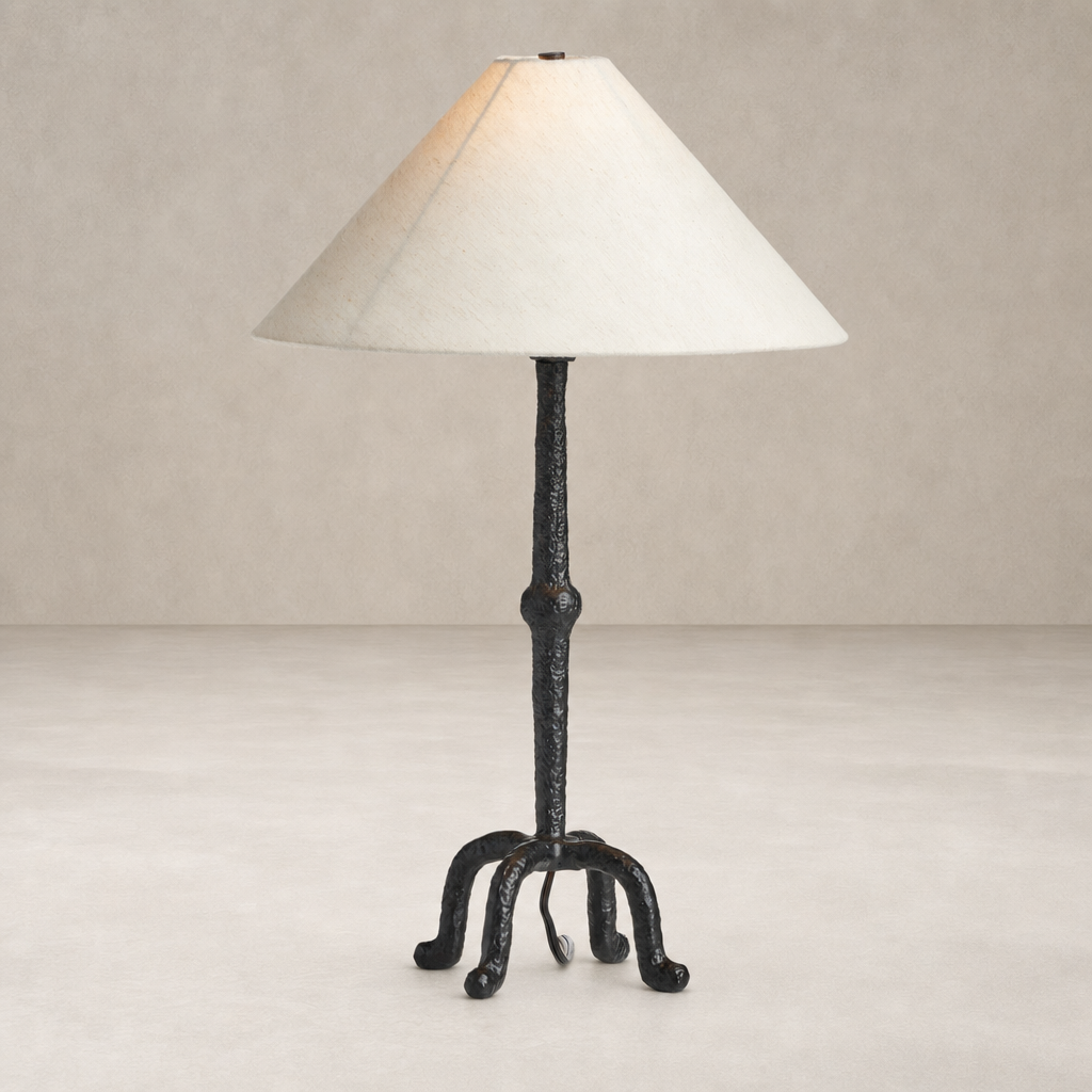 Matte black cast aluminum table lamp with a tapered shade, featuring a unique base.