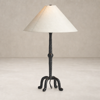 Matte black cast aluminum table lamp with a tapered shade, featuring a unique base.