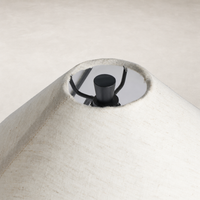 Matte black cast aluminum table lamp with a textured fabric shade detail.