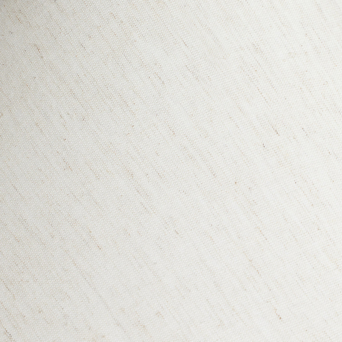 Close-up of a textured fabric lampshade in soft cream color.