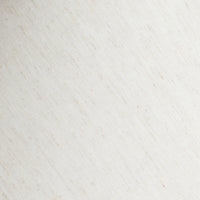 Close-up of a textured fabric lampshade in soft cream color.