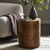 Zuri End Table featuring a round wood surface and unique textured finish, styled with decor.