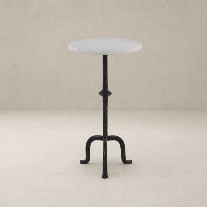 Esme End Table features a round marble top and intricate black metal base.