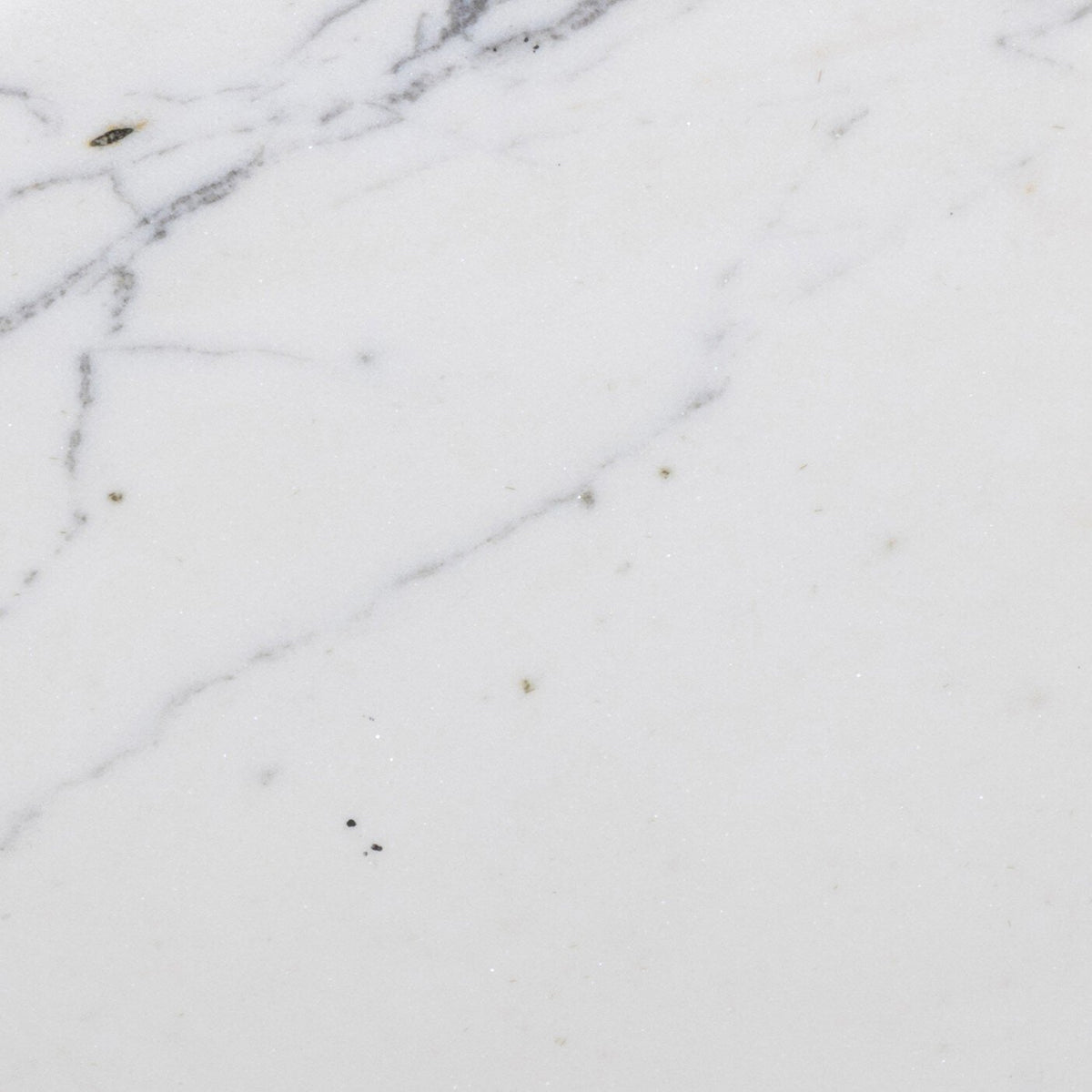 Close-up of the marble surface of the Esme End Table showing white with gray veining.