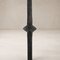 Esme End Table featuring a textured black pillar design with unique shape and details.