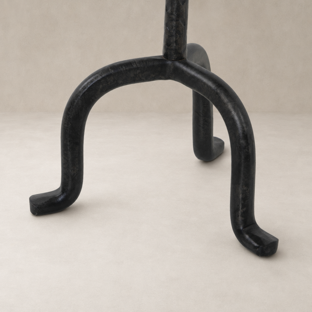 Esme End Table features a sleek black metal base with curved legs for stability.