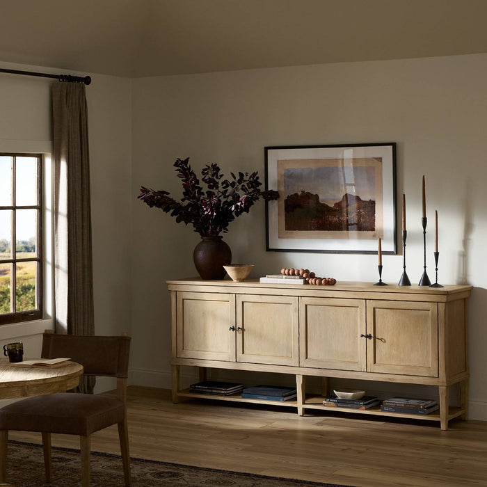 Henley Sideboard in aged light pine features three doors and an open shelf.