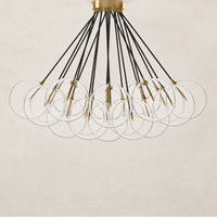Burnished brass chandelier with multiple clear glass orbs and black cords.