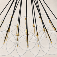 Burnished brass chandelier with clear glass globes and black wiring.