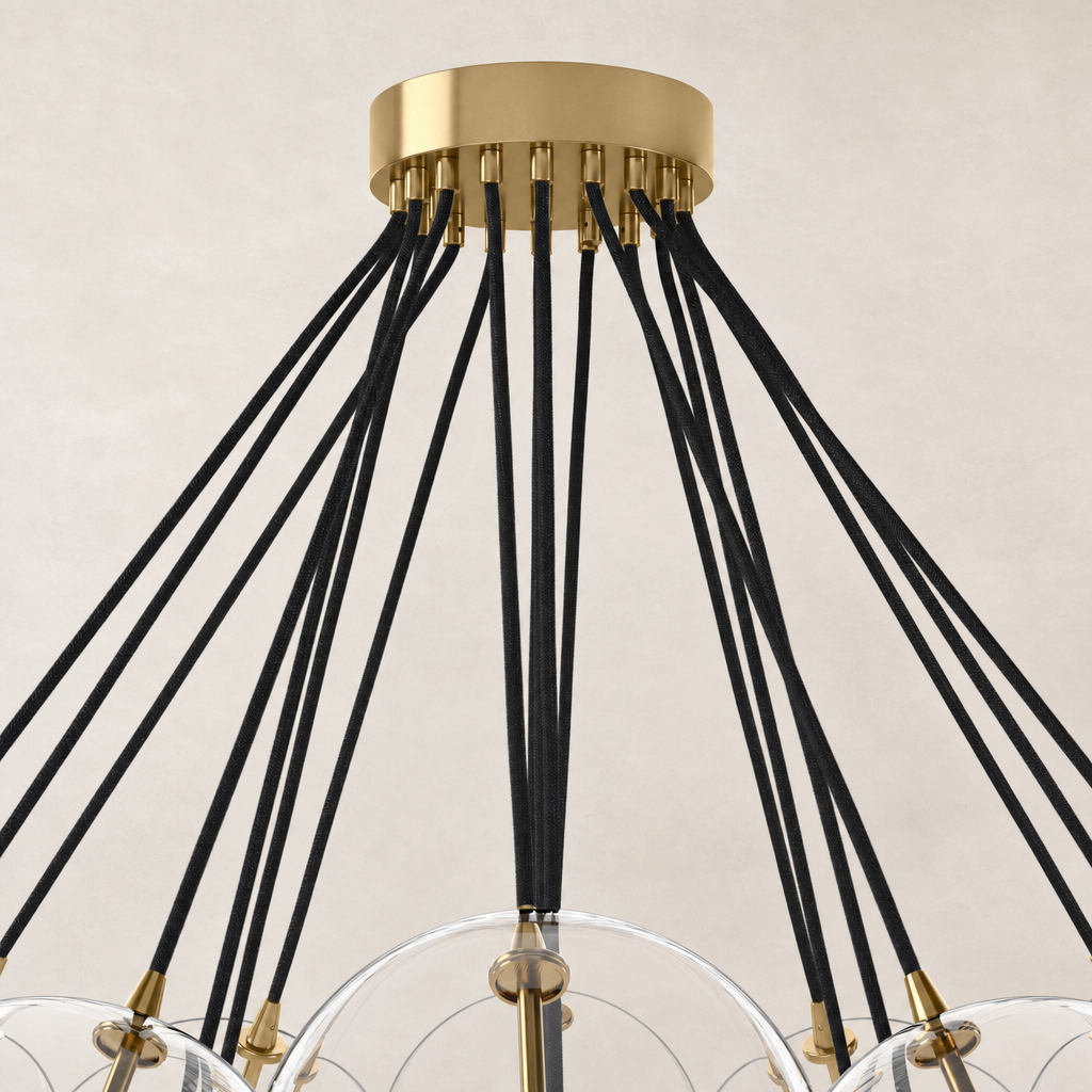 Burnished brass chandelier featuring unique black cord suspension and translucent globes.