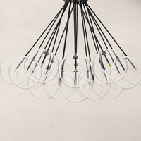 Black gunmetal chandelier with transparent circular shades and sleek design.