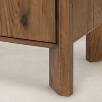 Close-up of Zuma Wide Bookshelf's sturdy legs and textured worn oak finish.