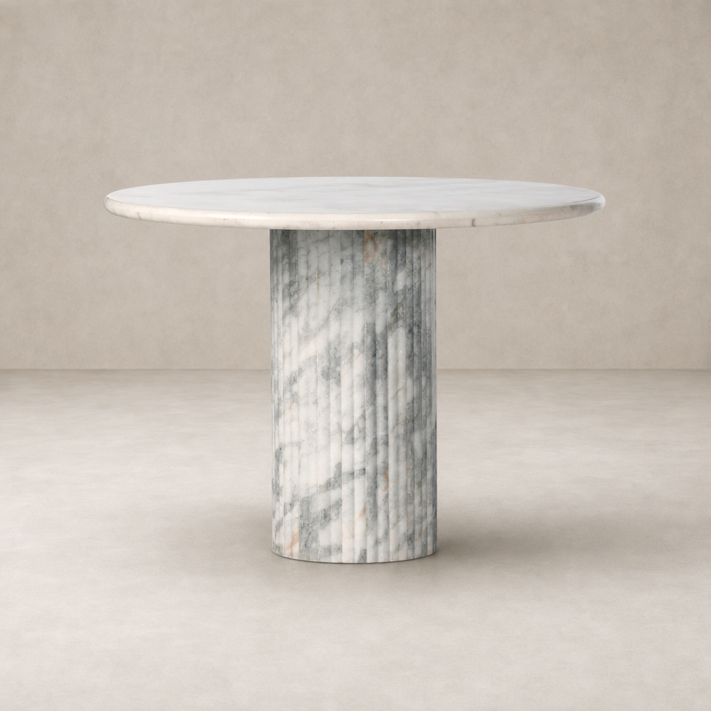Ilaria Round Dining Table 42 features a polished white marble top and textured column base.