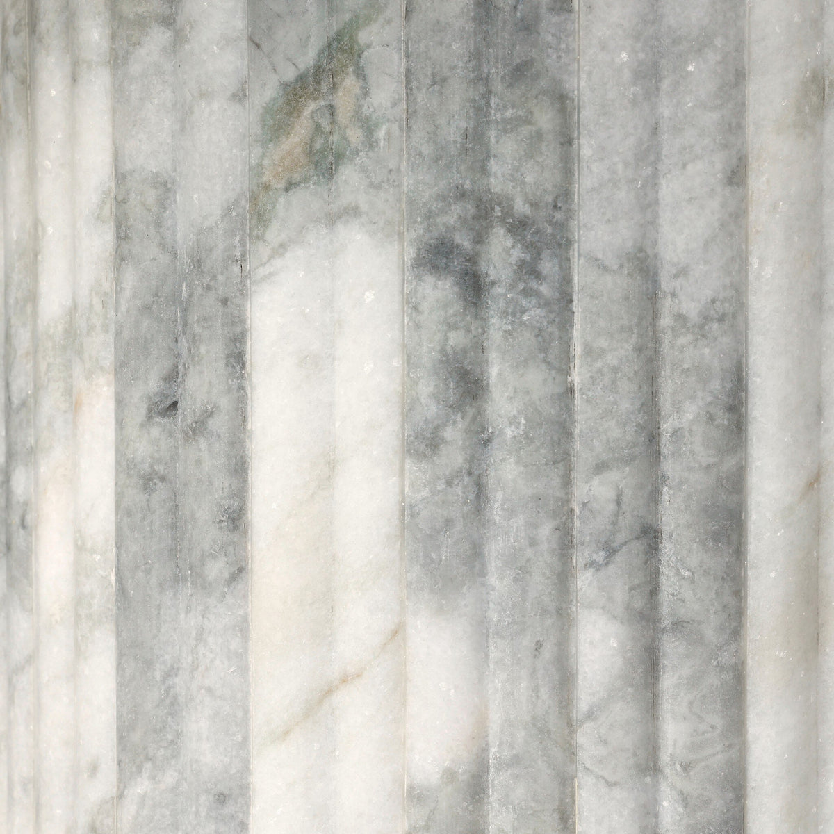 Close-up of the Ilaria Round Dining Table 42's polished white marble texture and veining.