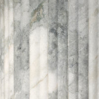Close-up of the Ilaria Round Dining Table 42's polished white marble texture and veining.