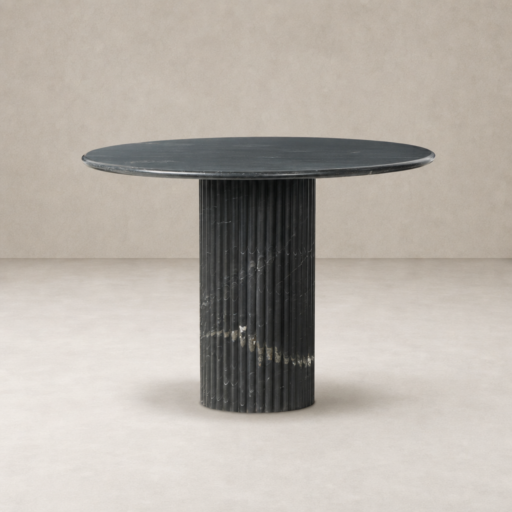 Ilaria Round Dining Table 42 features a sleek black marble top and ribbed pedestal base.