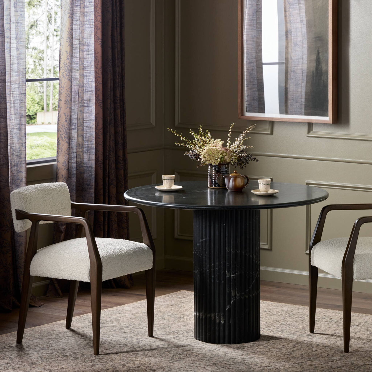Ilaria Round Dining Table 42 in elegant black marble with a sleek pedestal base.