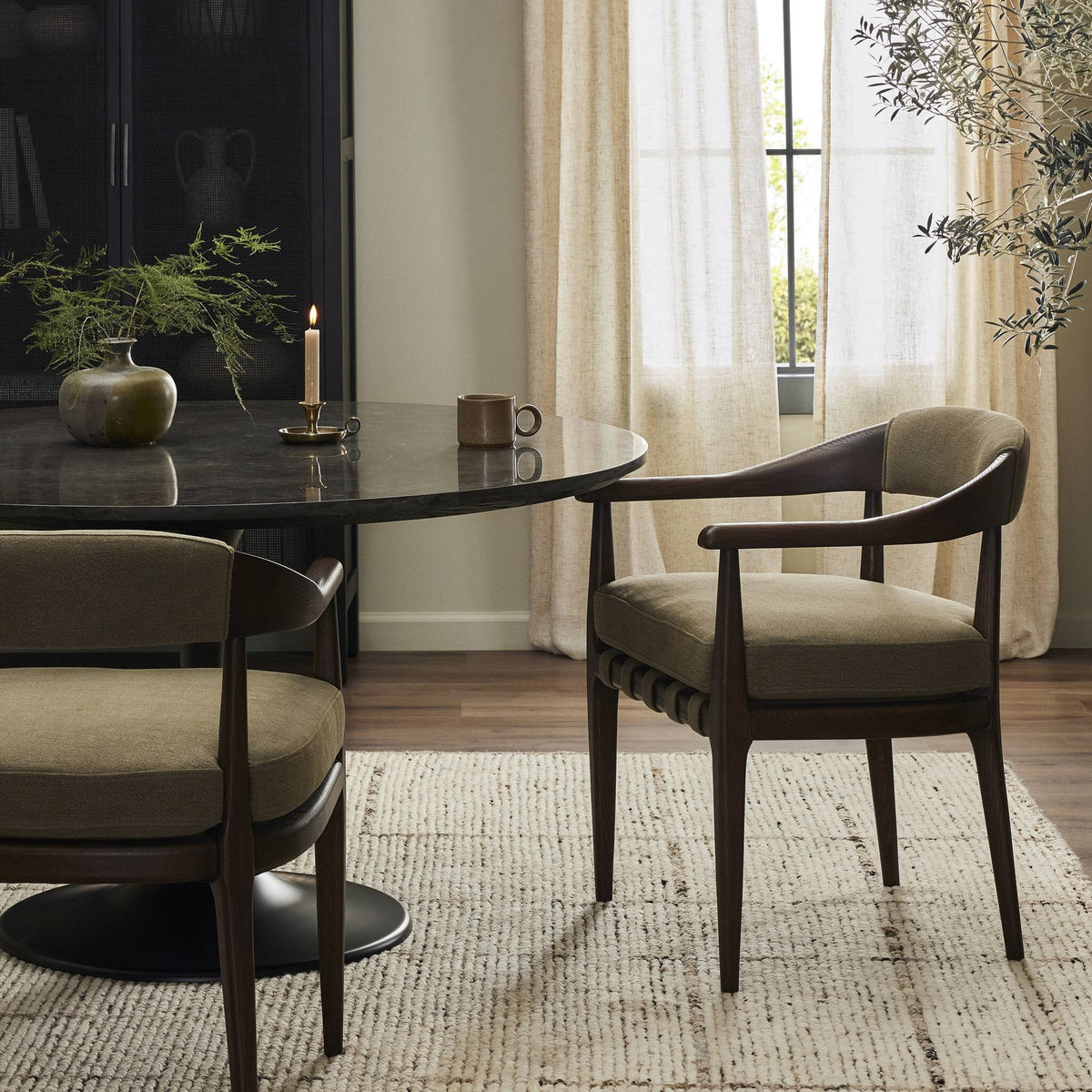 Nolan Dining Chair in Broadway Olive, featuring curved arms and comfortable upholstery.